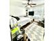 Well-lit bedroom with hardwood floors, ceiling fan, and a large patterned area rug at 1309 Harms Way, Port Orange, FL 32129