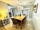 Bright dining room area with hardwood floors and modern chandelier lighting at 1309 Harms Way, Port Orange, FL 32129