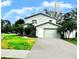 Charming two-story home with a well-manicured lawn and mature landscaping at 1309 Harms Way, Port Orange, FL 32129