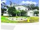 Beautifully landscaped front yard featuring a lush green lawn and ornamental plants at 1309 Harms Way, Port Orange, FL 32129