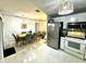 Bright kitchen featuring stainless steel appliances and a cozy dining area at 1309 Harms Way, Port Orange, FL 32129