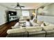 Inviting living room with hardwood floors, stylish furniture, and abundant natural light at 1309 Harms Way, Port Orange, FL 32129