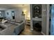 The living room is decorated with hardwood floors, a gray sofa, and custom storage units at 1309 Harms Way, Port Orange, FL 32129