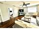 Cozy living room offering hardwood floors, a ceiling fan, and comfortable seating arrangements at 1309 Harms Way, Port Orange, FL 32129