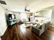 Inviting living room with stylish furniture, ceiling fan, and well-maintained hardwood floors at 1309 Harms Way, Port Orange, FL 32129