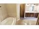 A spacious bathroom with a large soaking tub, walk-in shower, and dual sinks at 13157 Sw 35Th Cir, Ocala, FL 34473