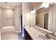 A bathroom with tile floors, a large mirror, dual sinks, and soaking tub at 13157 Sw 35Th Cir, Ocala, FL 34473