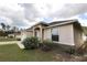 Side view showing the home's architectural details and landscaped front yard at 13157 Sw 35Th Cir, Ocala, FL 34473