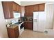 Well-lit kitchen features wood cabinets, granite counters, and white appliances at 13157 Sw 35Th Cir, Ocala, FL 34473