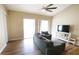 Spacious living room features a ceiling fan, sliding glass doors, and comfortable seating at 13157 Sw 35Th Cir, Ocala, FL 34473