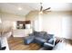 Spacious living room features an open kitchen view, ceiling fan, and comfortable seating area at 13157 Sw 35Th Cir, Ocala, FL 34473