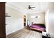A neutral bedroom with a ceiling fan, recessed lighting, and wood floors at 13157 Sw 35Th Cir, Ocala, FL 34473