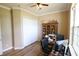 Office featuring a desk, storage, and natural light from a large window at 13157 Sw 35Th Cir, Ocala, FL 34473