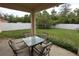 Outdoor patio with a table and chairs with a view of the fenced-in backyard at 13157 Sw 35Th Cir, Ocala, FL 34473