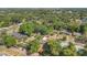 An aerial view of a home with a pool, surrounded by mature trees, near a lake at 1326 W Concord St, Orlando, FL 32805