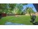 Spacious backyard featuring a large lawn, mature trees, and partial fencing for privacy at 1326 W Concord St, Orlando, FL 32805