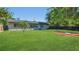 Expansive backyard featuring lush green grass, mature trees, and a well-maintained lawn at 1326 W Concord St, Orlando, FL 32805