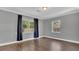 A cozy room with hardwood floors, neutral gray walls, and two windows providing natural light at 1326 W Concord St, Orlando, FL 32805