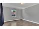 A spacious bedroom featuring hardwood floors, neutral gray walls, and one window at 1326 W Concord St, Orlando, FL 32805