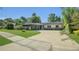Beautiful single-story home featuring a curved driveway, lush lawn, and attractive landscaping at 1326 W Concord St, Orlando, FL 32805