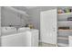 Functional laundry room with washer, dryer, shelving, and convenient access to utilities at 1326 W Concord St, Orlando, FL 32805