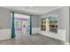 Living room with neutral paint, tile flooring and a view of the backyard through a large window at 1326 W Concord St, Orlando, FL 32805