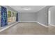 Spacious living room features neutral tile flooring and large windows offering lots of natural light at 1326 W Concord St, Orlando, FL 32805