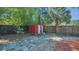 Backyard shed featuring a red and white exterior with a functional door, providing additional storage space at 1326 W Concord St, Orlando, FL 32805