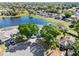 Aerial view of neighborhood with a lake and homes with swimming pools at 134 Foggy Creek Ct, Davenport, FL 33837