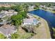 Aerial view of backyard with a large lake, screened in pool, and wood fence at 134 Foggy Creek Ct, Davenport, FL 33837