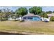 View of fenced backyard featuring a screened in pool and lake at 134 Foggy Creek Ct, Davenport, FL 33837