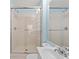 Bathroom featuring a glass enclosed shower, toilet, sink, and mirror at 134 Foggy Creek Ct, Davenport, FL 33837