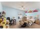Cozy bedroom featuring a comfortable bed, ample natural light, and a personal desk area at 134 Foggy Creek Ct, Davenport, FL 33837