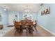 Dining room with a wooden table, 8 chairs, artwork, and light blue walls at 134 Foggy Creek Ct, Davenport, FL 33837
