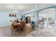 Dining room adjacent to kitchen and living area featuring wood table set and hardwood floors at 134 Foggy Creek Ct, Davenport, FL 33837
