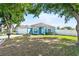 Charming single-story home with blue exterior, well-maintained lawn, and a two car garage at 134 Foggy Creek Ct, Davenport, FL 33837