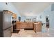 Spacious kitchen with wood cabinets, stainless steel appliances, and an eat-in area at 134 Foggy Creek Ct, Davenport, FL 33837