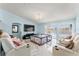 Bright living room featuring tile floors, vaulted ceilings, and theater style seating at 134 Foggy Creek Ct, Davenport, FL 33837