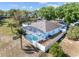 Aerial view of backyard featuring a screened pool with a privacy fence and sunny skies at 134 Foggy Creek Ct, Davenport, FL 33837