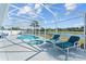 Serene screened pool and spa with scenic lake views, ideal for relaxation and entertaining at 134 Foggy Creek Ct, Davenport, FL 33837