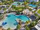Stunning aerial view of multiple community pools, palm trees, and amenities for the ultimate in resort-style living at 13890 Sato Ave, Orlando, FL 32827