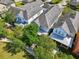 An aerial view shows a series of well-maintained homes with neutral exteriors and lush landscaping at 13890 Sato Ave, Orlando, FL 32827