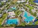 A high view of the community pools, volleyball court, and surrounding amenities from the community at 13890 Sato Ave, Orlando, FL 32827