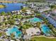 Overhead view of a community with multiple pools and amenities, surrounded by lush landscaping and homes at 13890 Sato Ave, Orlando, FL 32827