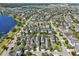 An aerial view displays residences along tree-lined streets, highlighting the neighborhood's proximity to a large lake at 13890 Sato Ave, Orlando, FL 32827
