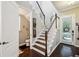 Welcoming entryway with hardwood floors, staircase, and a convenient half-bathroom at 13890 Sato Ave, Orlando, FL 32827