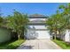 Charming home featuring a two-car garage with a well maintained lawn at 13890 Sato Ave, Orlando, FL 32827