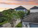 Two-story home featuring light blue siding, a gray roof, and mature landscaping at 13890 Sato Ave, Orlando, FL 32827