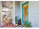 Charming front porch with brick flooring, seating, and a bright blue front door at 13890 Sato Ave, Orlando, FL 32827