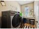 Functional laundry room featuring modern washer and dryer, ample counter space, and storage solutions at 13890 Sato Ave, Orlando, FL 32827